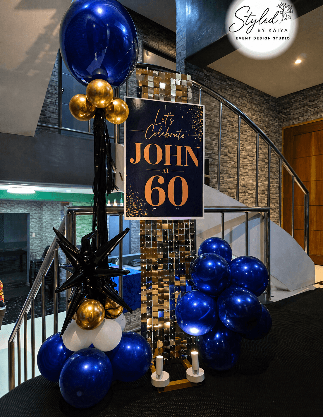 John's 60th birthday party entrance with navy blue and gold sequin decor