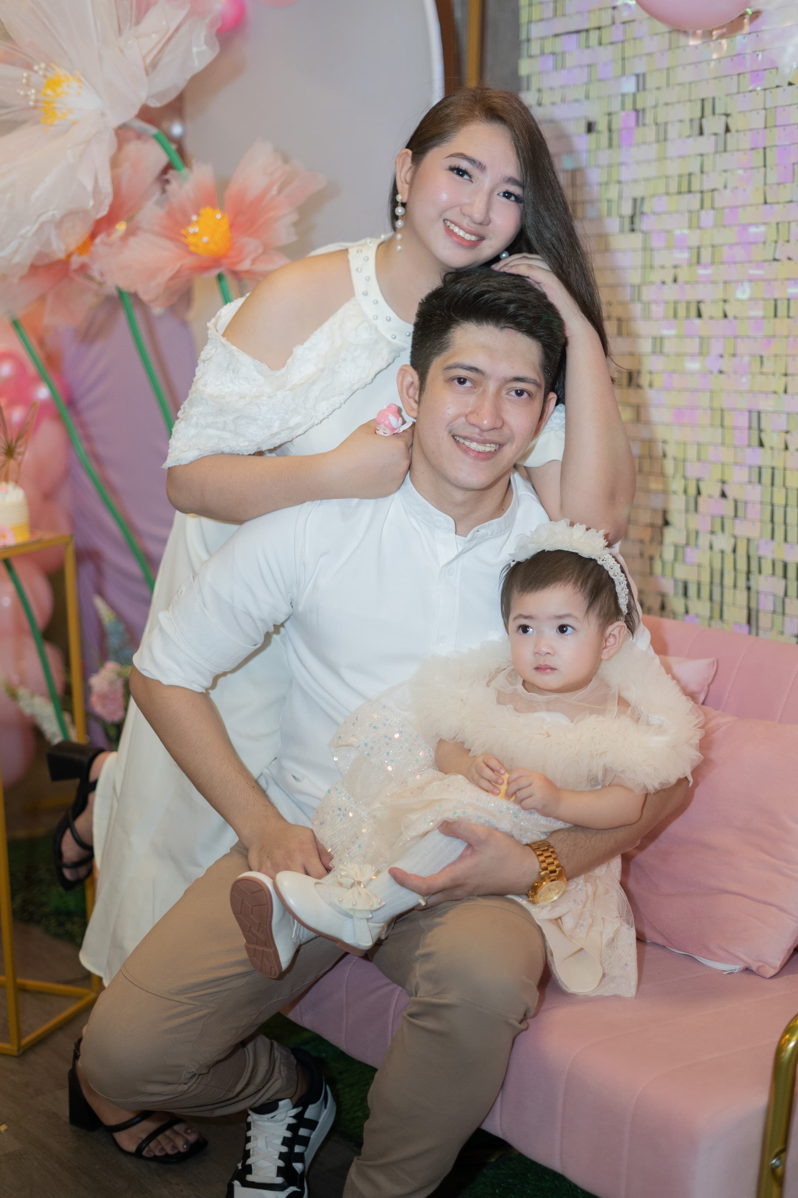Parents with baby Lian Kayla at the fairy garden birthday setup