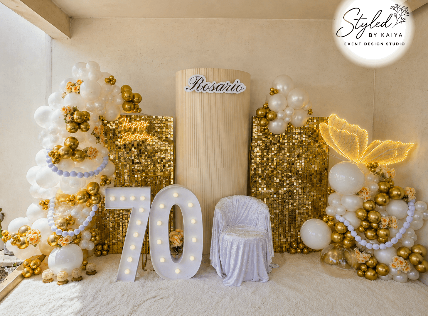 Rosario's 70th birthday gold sequin backdrop with butterfly lights and pearl details