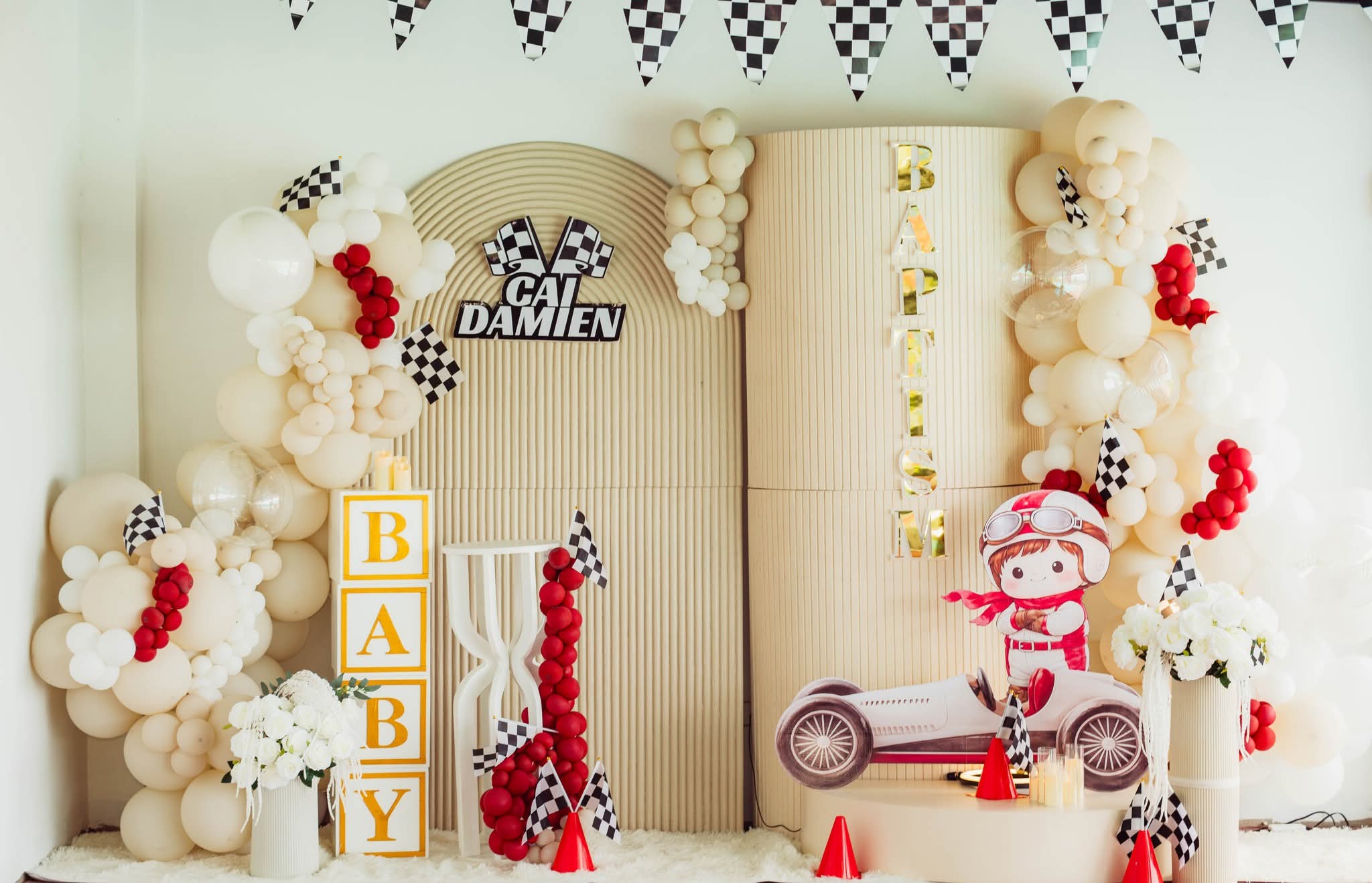 Cai Damien christening main arch backdrop with checkered racing flag decor