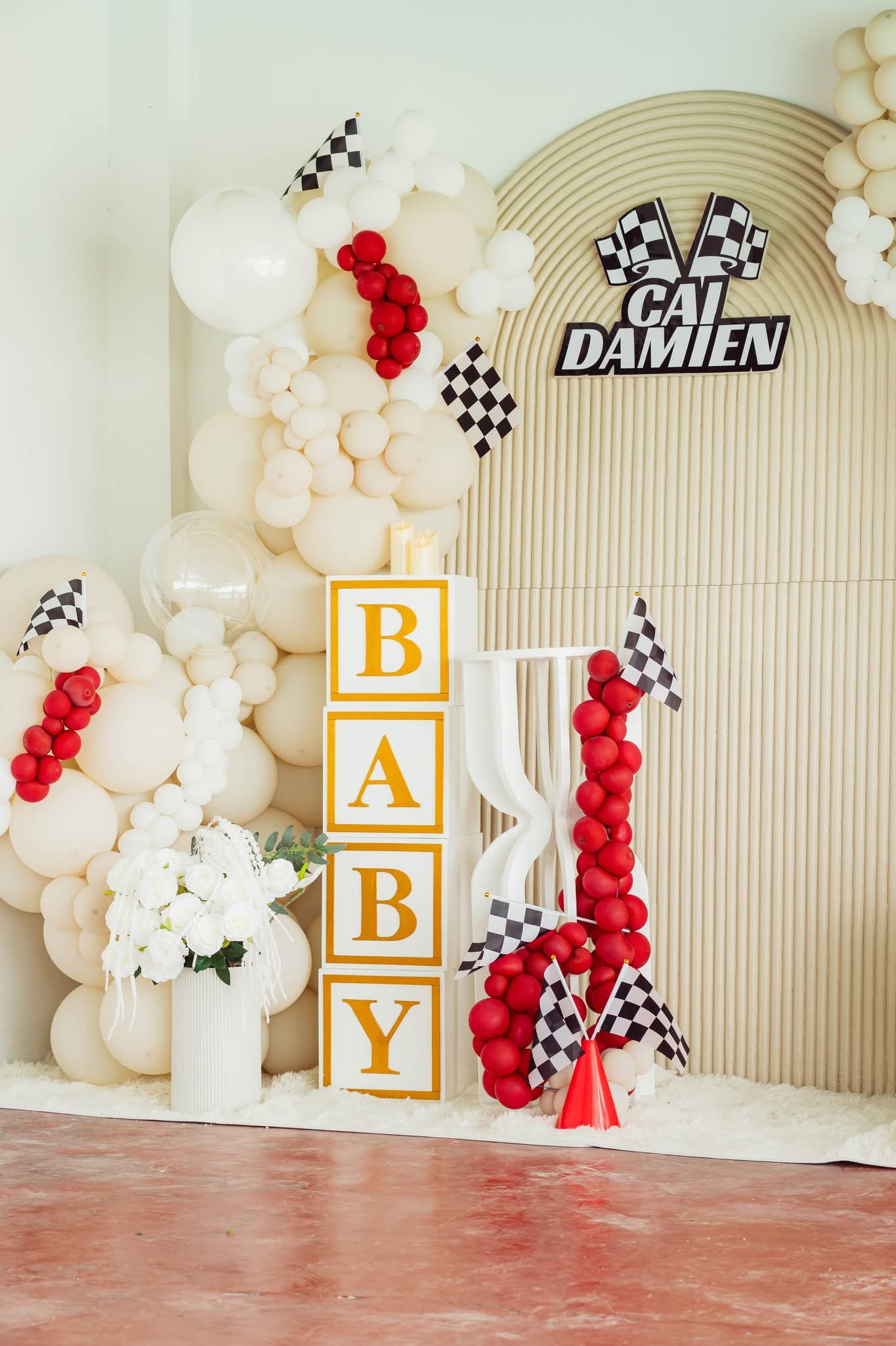 BABY letter blocks beside the Cai Damien christening arch