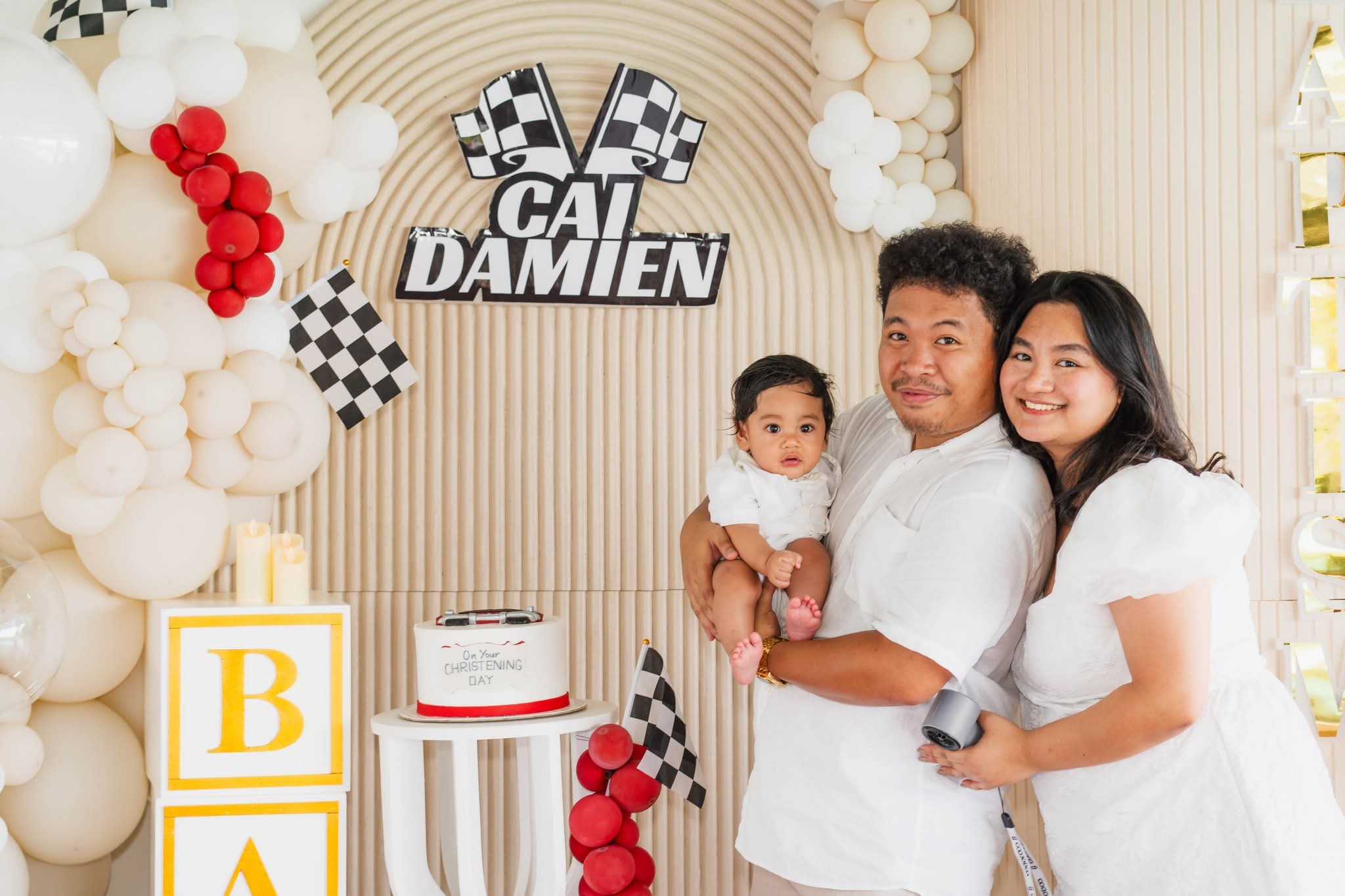 Family portrait with baby at Cai Damien's racing christening on his special day