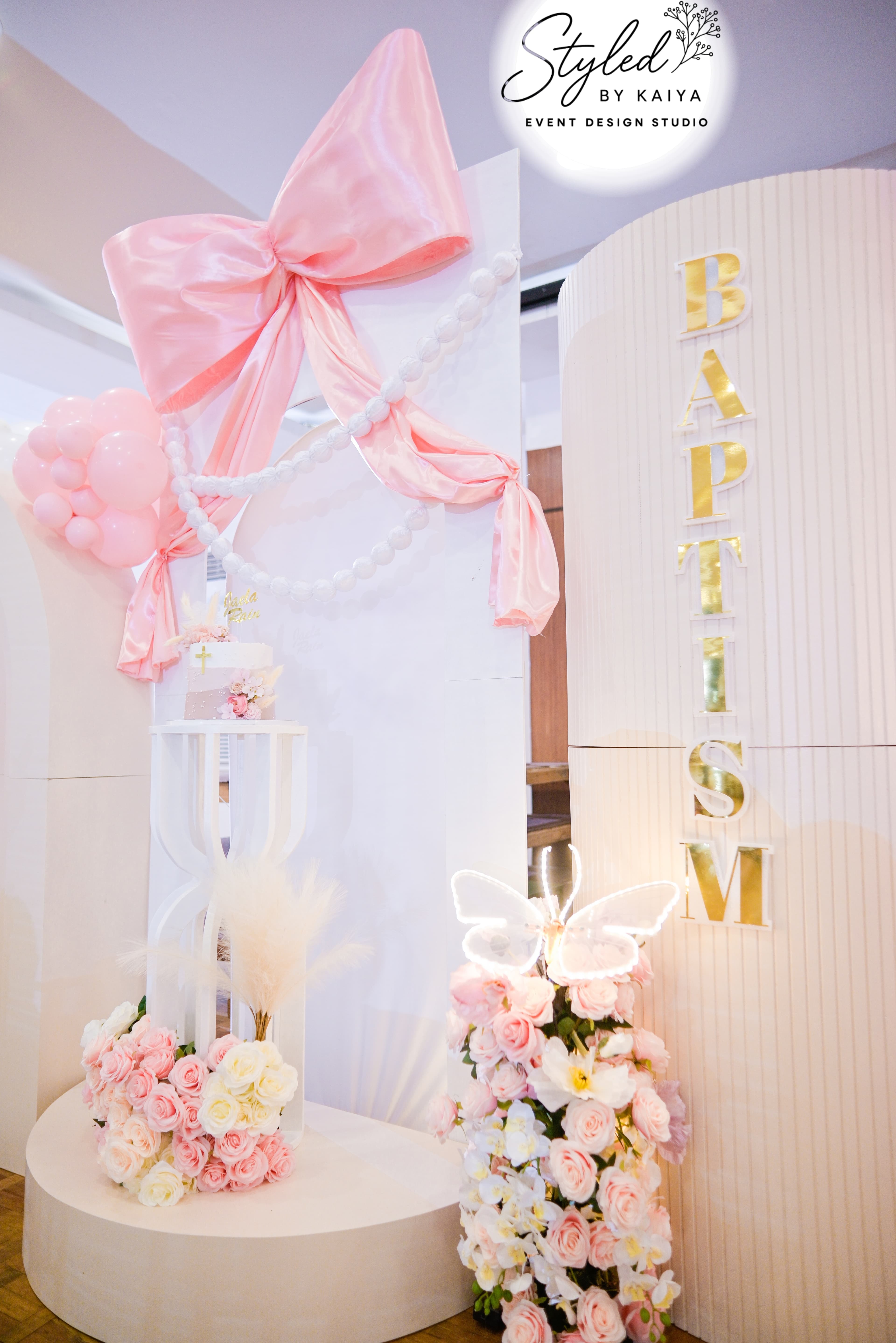 BAPTISM marquee letters with oversized pink bow and floral arrangement