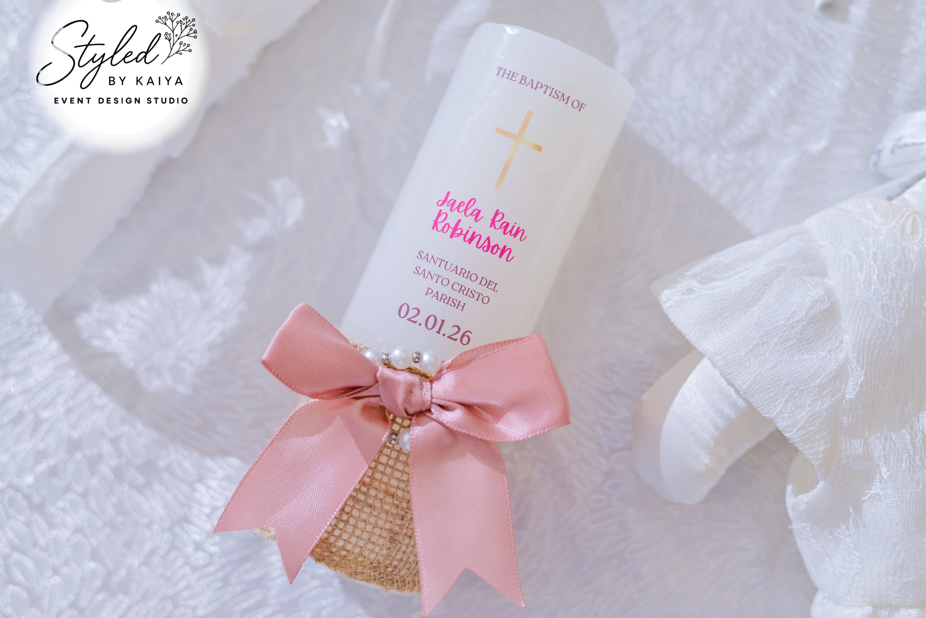 Personalized christening candle with pink satin ribbon and pearl details