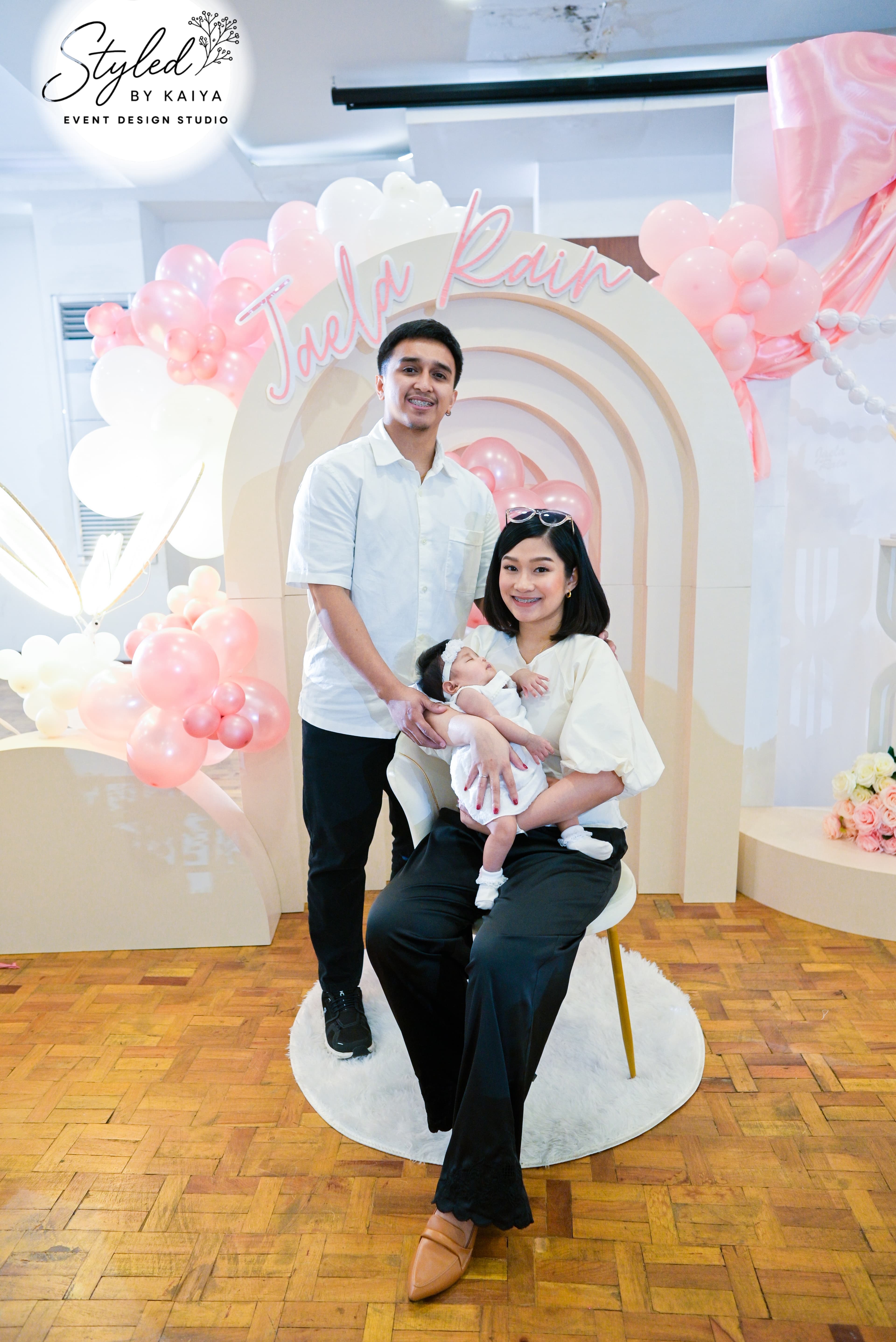 Family portrait at Jaela Rain's christening rainbow photo nook