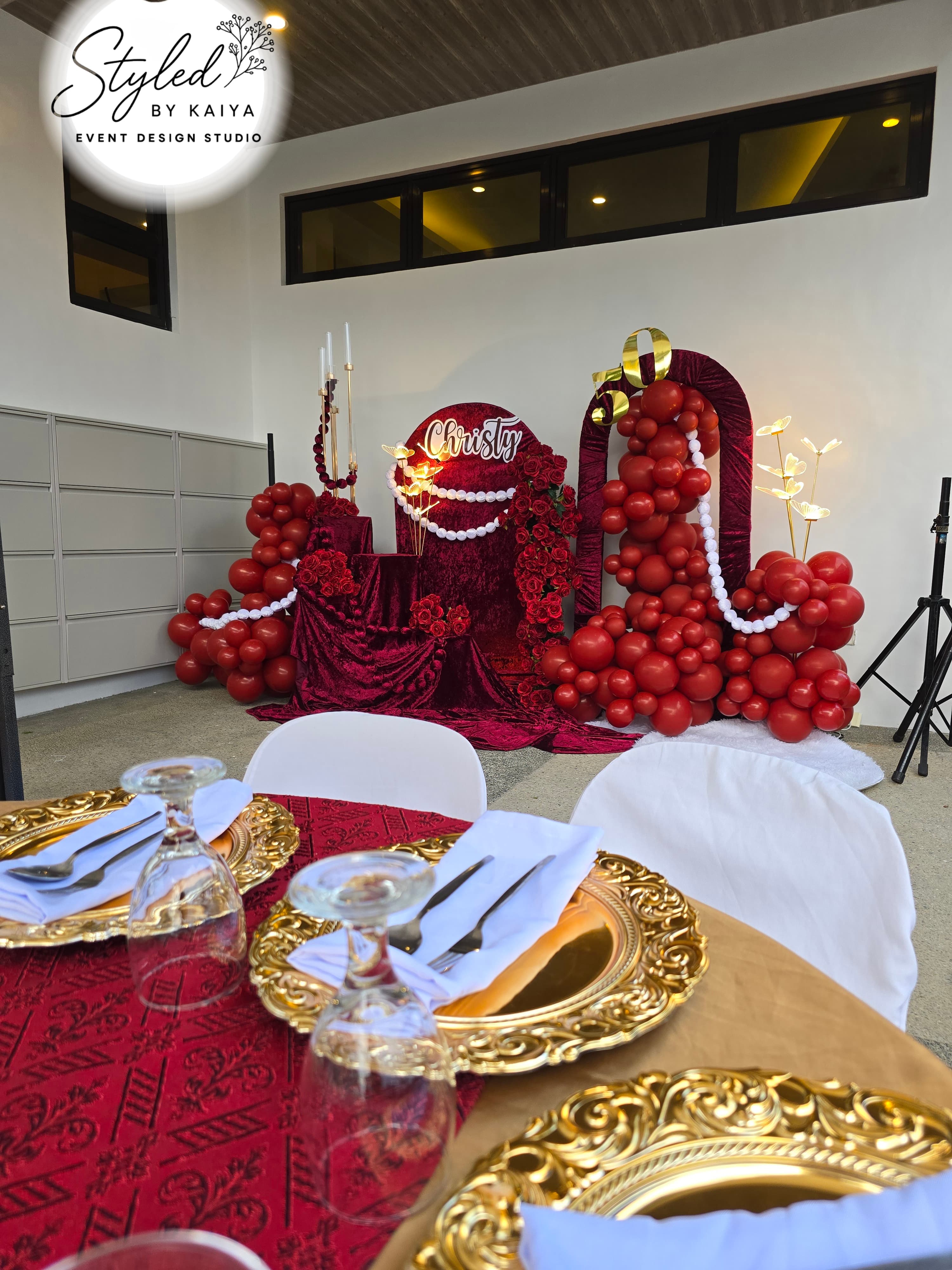 Christy's debut table styling with elegant crimson and gold centerpieces