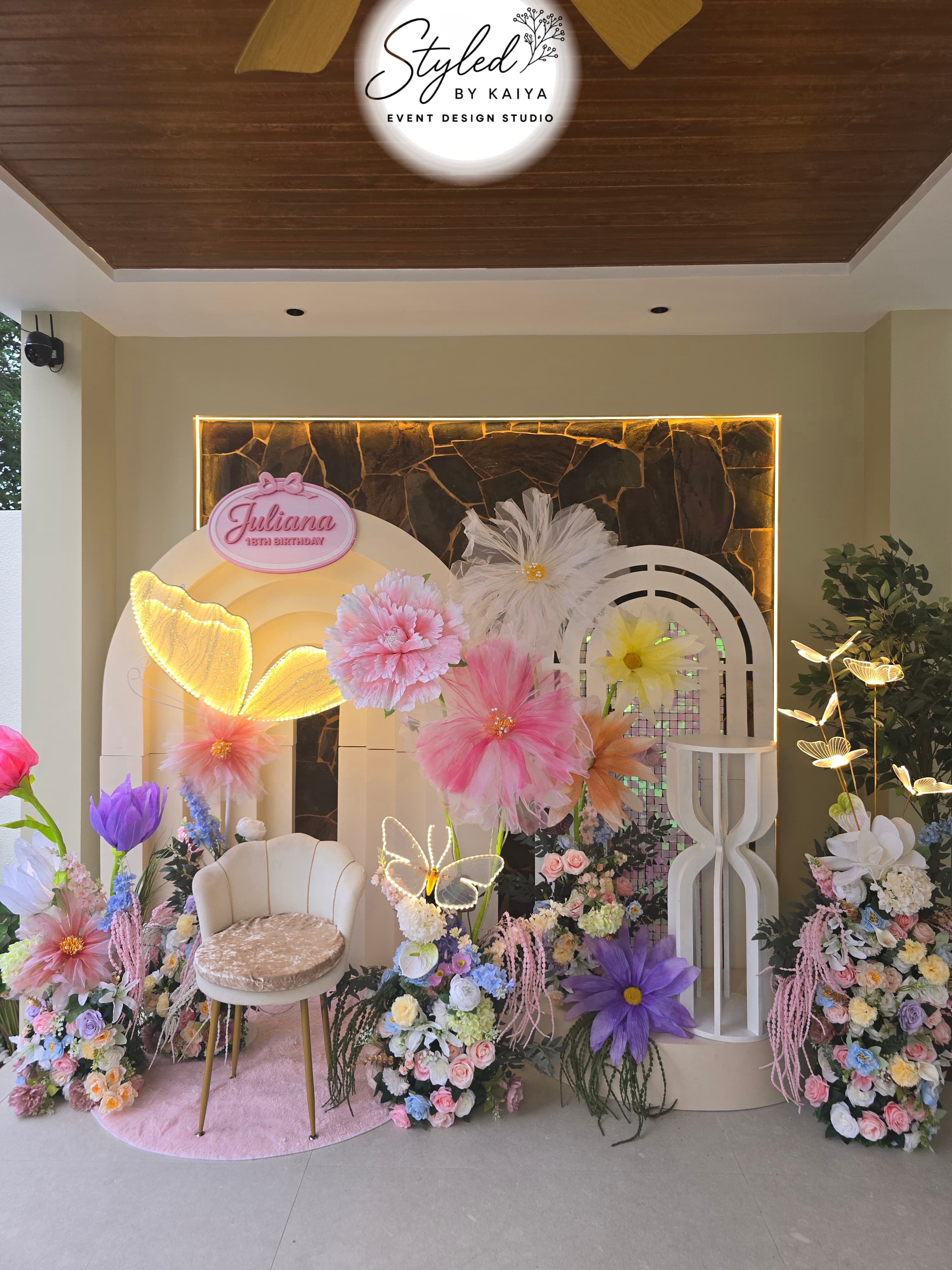 Juliana's 18th birthday wide floral butterfly setup with layered flower arch