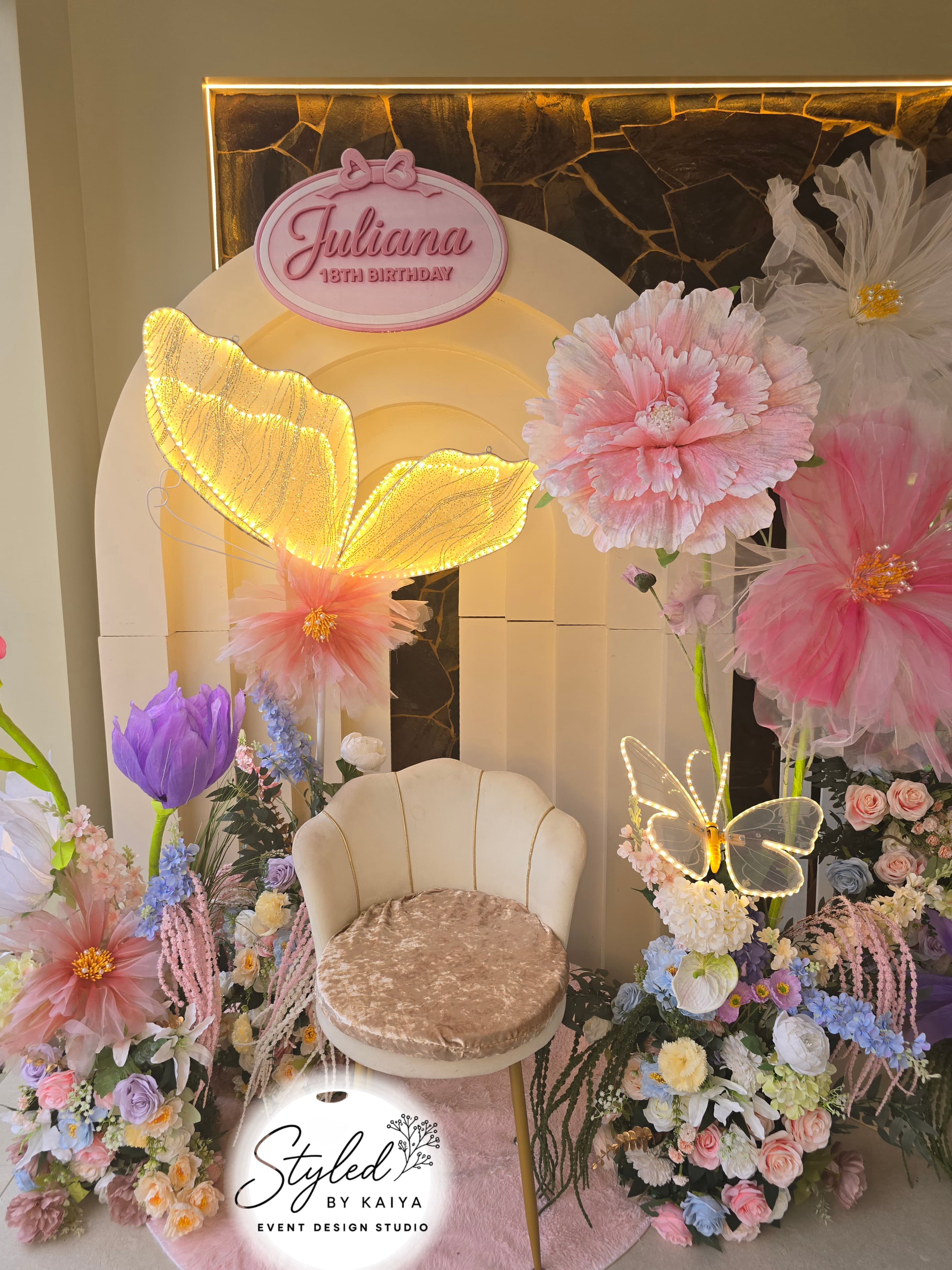 Juliana's 18th birthday photo nook with butterfly light and flower arch